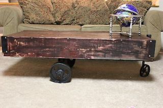 Reclaimed wood industrial unique coffee table on iron wheels