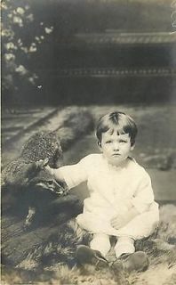 REAL PHOTO SOMBER CHILD ON FUR RUG STUFFED ANIMAL K36117