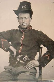   soldier in Union artillery uniform with Hardee hat,revolver