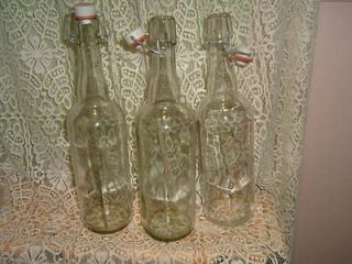   EMPTY WINE TYPE BOTTLES WITH ATTACHED CAPS MAYBE FOR VINEGAR MAKING