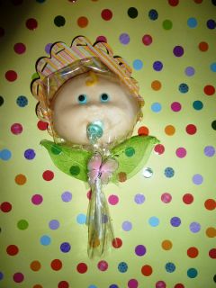   in chocolate with flower bonnet , pacifier, leaves and a butterfly