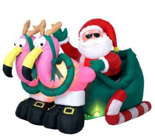 Inflatable Santa in Sleigh with Pink Flamingos —