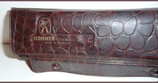 The Hohner case is also in good condition for its age. One snap has a