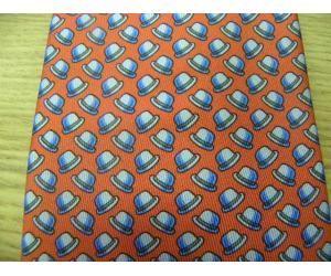 Hermes red silk tie with white/blue hat print throughout. Comes in