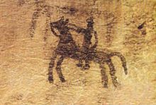 prehistoric cave painting depicting a horse and rider