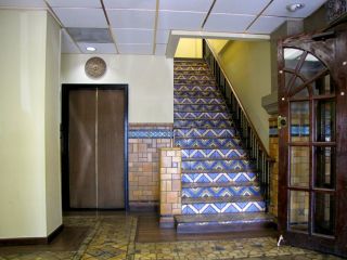 The floor and walls are faced with decorative tile as are the stair