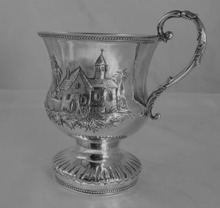  REPOUSSE FOOTED CUP CREATED BY THE FIRM OF GOULD, STOWELL, & WARD