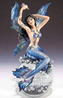 Mermaid with blue scales and fins on solid glass ball mythical fantasy