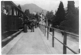 Photo Railway station,Menaggio,Italy,people boarding train,locomotive