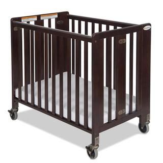 Foundations Hideaway Folding Compact Crib In Antique Cherry